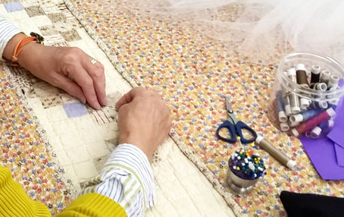 Meg sews netting to one of our new acquisitions to the Collection