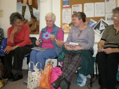 Quilters from the visiting group sharing their 'travel quilts'