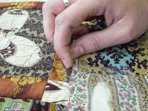 The Red Manor House Coverlet being conserved